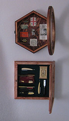 A glass front cabinet displaying 
antique razors